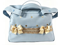 A light blue handbag with a top handle, decorative gold-tone studs, a beige lace band, and two large gold satin bows on the front, shown against a plain white background.