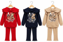 Load image into Gallery viewer, Three girls' two-piece sweatshirt and pants sets hanging on wooden hangers against a white background. The left set is red, the middle is navy blue, and the right set is beige.