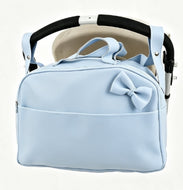 A light blue baby stroller bag with a matching fabric bow on the front, designed to hang from a stroller handle. The bag is shown hanging from a black and beige stroller handle against a clean white background.